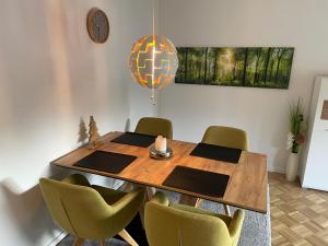 a dining room with a wooden table and chairs at Ferienwohnung „Am Rodenberg“ in Bad Harzburg