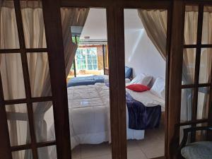 a small bedroom with a bed and a window at El Portal de Mariana in Pereira