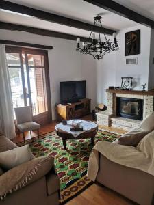 a living room with a couch and a fireplace at Ξενώνας Άνθεμις in Levidi