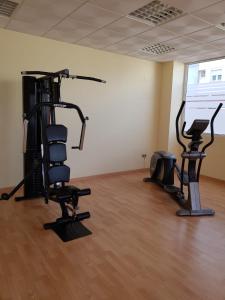 a gym with two exercise bikes and a treadmill at HR PARADISE CALA DE LA VILA JOIOSA in Cala de Finestrat