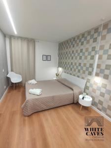 Posteľ alebo postele v izbe v ubytovaní white caves catania rooms