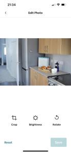 a screenshot of a kitchen with a picture of a refrigerator at Cosy seaside cottage in Criccieth