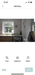 a screenshot of a kitchen with a sink and a window at Cosy seaside cottage in Criccieth