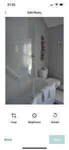 a bathroom with a white tub and a toilet at Cosy seaside cottage in Criccieth