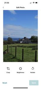 a screenshot of a cell phone of a field with a fence at Cosy seaside cottage in Criccieth