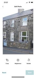 a screenshot of a stone house with two windows at Cosy seaside cottage in Criccieth