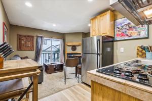 a kitchen with a stainless steel refrigerator and a table at Tannhauser II 15 in Breckenridge