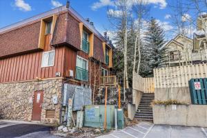 an apartment building with a staircase and a fence at Tannhauser II 15 in Breckenridge