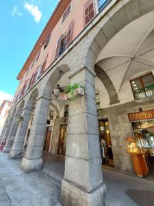 a building with arches on the side of a street at Boigne Sweet Suite in Chambéry