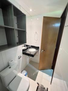a bathroom with a toilet and a sink and a shower at Prédio Solar do Atlântico - Apartamento lateral em Tambaú in João Pessoa