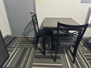 a dining room table and chairs in a room at Relax Inn - Saginaw in Saginaw