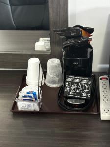 a tray with a coffee maker and other items at Relax Inn - Saginaw in Saginaw