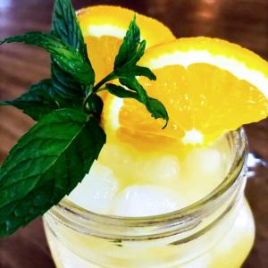 a jar of lemonade with lemon slices and mint at Hotel Ronda Valley in Ronda