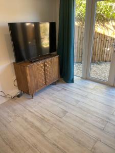 a flat screen tv sitting on top of a entertainment center at Crab Cottage in Wells next the Sea