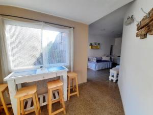 Alma viajera في بوساداس: غرفة معيشة مع طاولة وكراسي ونافذة