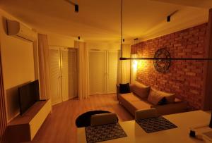 - un salon avec un canapé et un mur en briques dans l'établissement LakeView, à Ełk