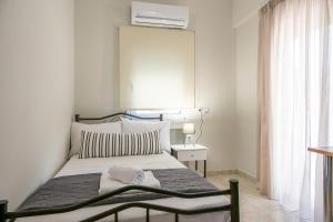 Ένα ή περισσότερα κρεβάτια σε δωμάτιο στο Elyzabeth Garden Apartment