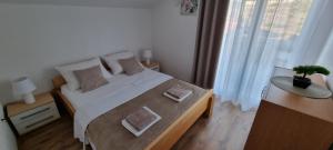Postel nebo postele na pokoji v ubytování Apartments Ćosic