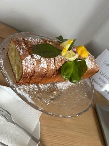 a glass plate with a piece of cake on a table at Torre Bonera. Green Resort in Menfi