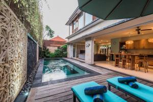 a swimming pool in the backyard of a house at Villa Lacasa2- modern tropical 2BR Villa with butler in Legian