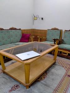 a coffee table with a laptop on top of it at Five Giants Lahore Homestay in Lahore