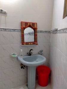 a bathroom with a sink and a mirror on the wall at Five Giants Lahore Homestay in Lahore