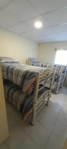 a hospital room with a table with pillows on it at Departamento ANGOSTURA in General Alvear