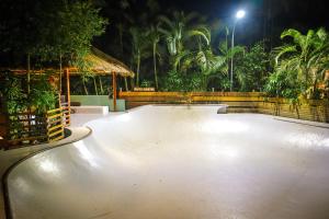an empty skate park at night with palm trees at Pipes Hostel in Kuta Lombok