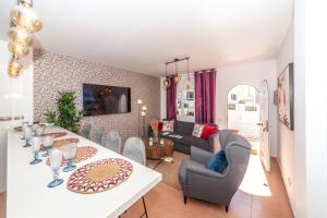 a dining room and living room with a table and chairs at Luxury Beach Tanza in Playa Honda