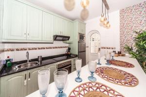 a kitchen with a table with wine glasses on it at Luxury Beach Tanza in Playa Honda