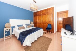 a bedroom with a bed and a flat screen tv at Luxury Beach Tanza in Playa Honda