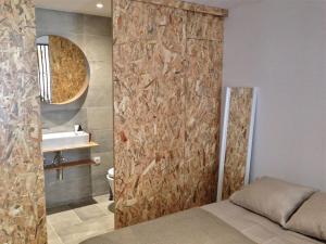 a bathroom with a bed and a sink and a mirror at Casa da Travessa in Lisbon