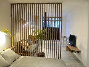a bedroom with a bed and a sliding glass door at Casa da Travessa in Lisbon