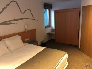 a bedroom with a bed with a mountain mural on the wall at Alpine Club Apartement für 6 Personen in Schladming +6 photos
