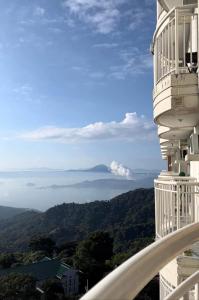 a balcony of a building with a view of the mountains at B123 Unit 1852 Prime Residences Tagaytay in Tagaytay