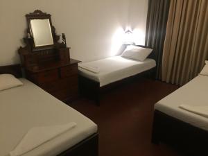 Postel nebo postele na pokoji v ubytování Galle Rest Home