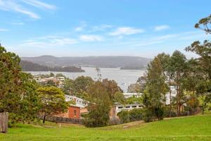 a view of the water from a park at The Tree Motel in Narooma