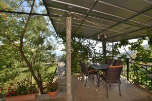 a table and chairs under a pergola on a patio at Apartment Gianfranko in Opatija