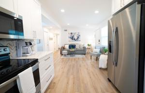 a kitchen with a refrigerator and a living room at Calming And Renovated Near Dt St Pete Pier 2 King in St. Petersburg