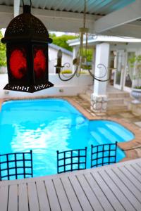 a chandelier hanging over a swimming pool at Bergview Guesthouse Swellendam in Swellendam