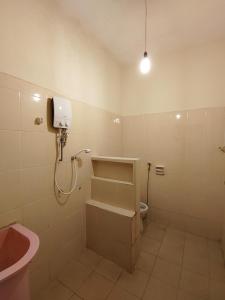 a bathroom with a shower and a sink and a toilet at GP Hostel Penang in George Town