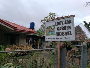 a sign for a garden hospital in front of a house at LHOYJEAN Garden Hostel in Batuan