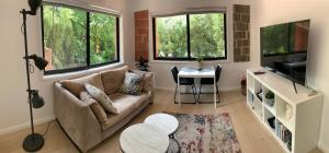 a living room with a couch and a table at Adorable 1 bedroom private apartment in Bright