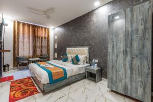 a bedroom with a bed and a large wall at DIPLOMAT REGENCY in New Delhi