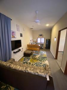 a living room with a couch and a table at MAMA homestay in Bagan Serai