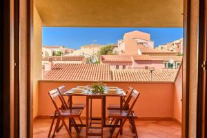 a table and chairs on a balcony with a view at Apartments with swimming pool in Santa Teresa di Gallura in Santa Teresa Gallura