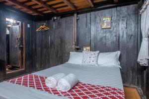 a bed in a room with wooden walls at Swasthi Serviced Villa in Kanjirapalli