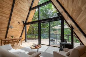 an open living room with large windows and a table at A-Frame House Minami Karuizawa - Vacation STAY 58046v in Karuizawa