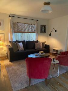 a living room with a couch and a table at Rock Rose Cottage in Trinidad