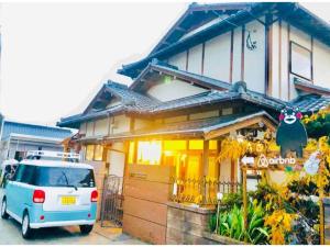 a small van parked in front of a house at Kumamoto Farm Stay - Vacation STAY 12032v in Takemiya